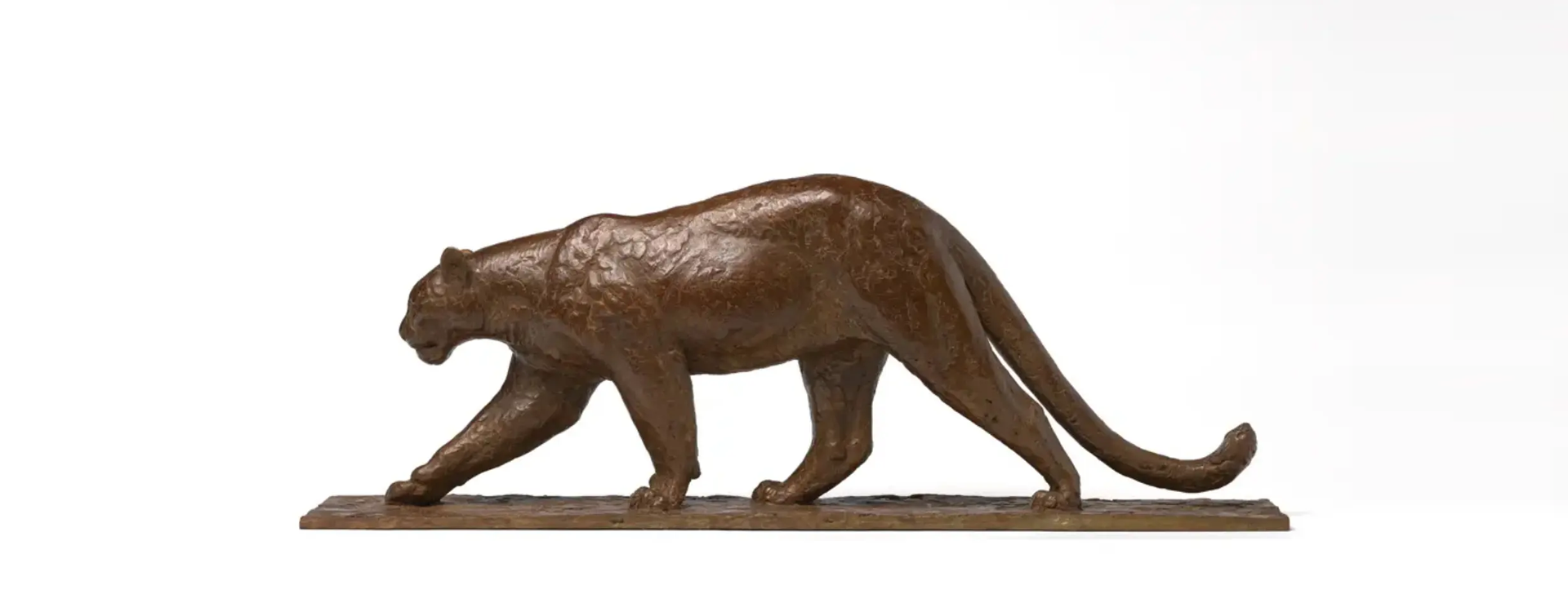 A bear statue is shown in bronze.